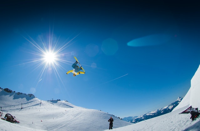 man-performing-snowboard-stunts