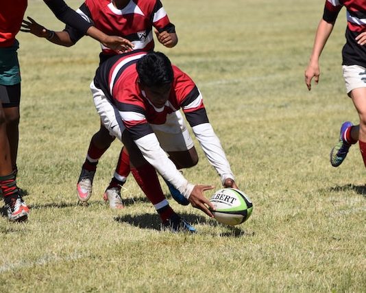 South African Rugby News man-in-red-and-white-striped-soccer-jersey-shirt-holding-white-and-blue-soccer-ball