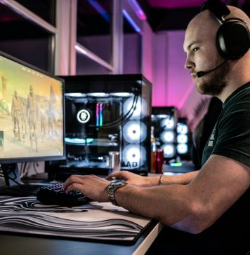 Guide to the 10 Best Gaming Blogs for Lore a-man-sitting-in-front-of-a-computer-with-headphones